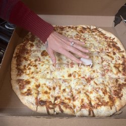 Bravo Pizza - A comparison of my wife's hand and how big the pizza was!