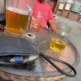 a man sitting at a table with a glass of beer