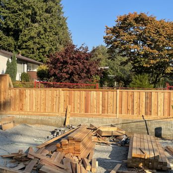 De Castro Contracting - a pile of wood in front of a fence - Landscaping Near Me - Coquitlam, British Columbia