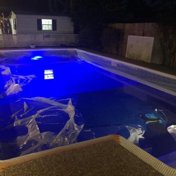 T&H Construction - a swimming pool at night - Flooring Near Me