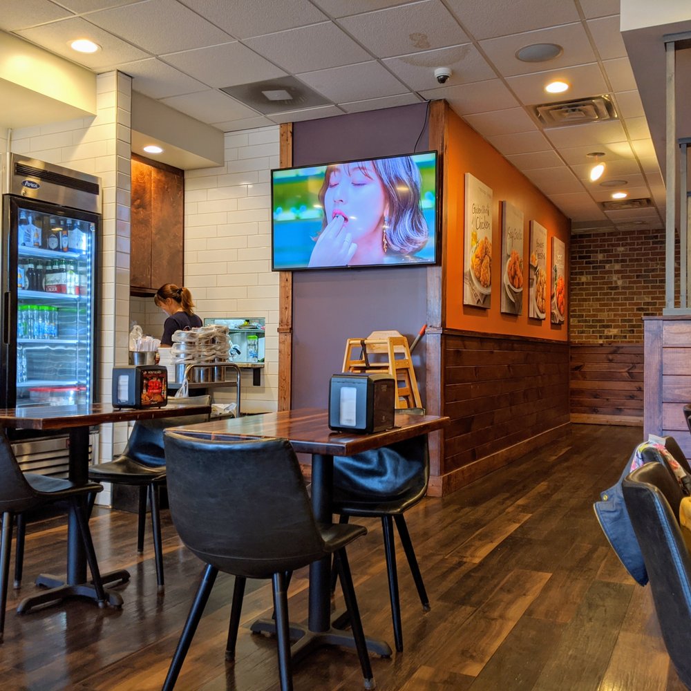 bb.q Chicken Duluth - Inside. Dining room. Window to kitchen. They have a single screen playing K-pop M/Vs with the sound piped throughout the entire restaurant. - Korean Near Me - Duluth, Georgia bb.q Chicken Duluth - Inside. Dining room. Window to kitchen. They have a single screen playing K-pop M/Vs with the sound piped throughout the entire restaurant. - Korean Near Me - Duluth, Georgia