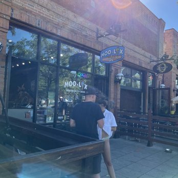 Moo-Lix - a man and a woman standing in front of a coffee shop - Ice Cream & Frozen Yogurt Near Me - Kelowna, British Columbia Moo-Lix - a man and a woman standing in front of a coffee shop - Ice Cream & Frozen Yogurt Near Me - Kelowna, British Columbia