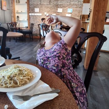 Oliver’s - a woman sitting at a table with a plate of spaghetti - Salad Near Me - Ste. Genevieve, Missouri Oliver’s - a woman sitting at a table with a plate of spaghetti - Salad Near Me - Ste. Genevieve, Missouri