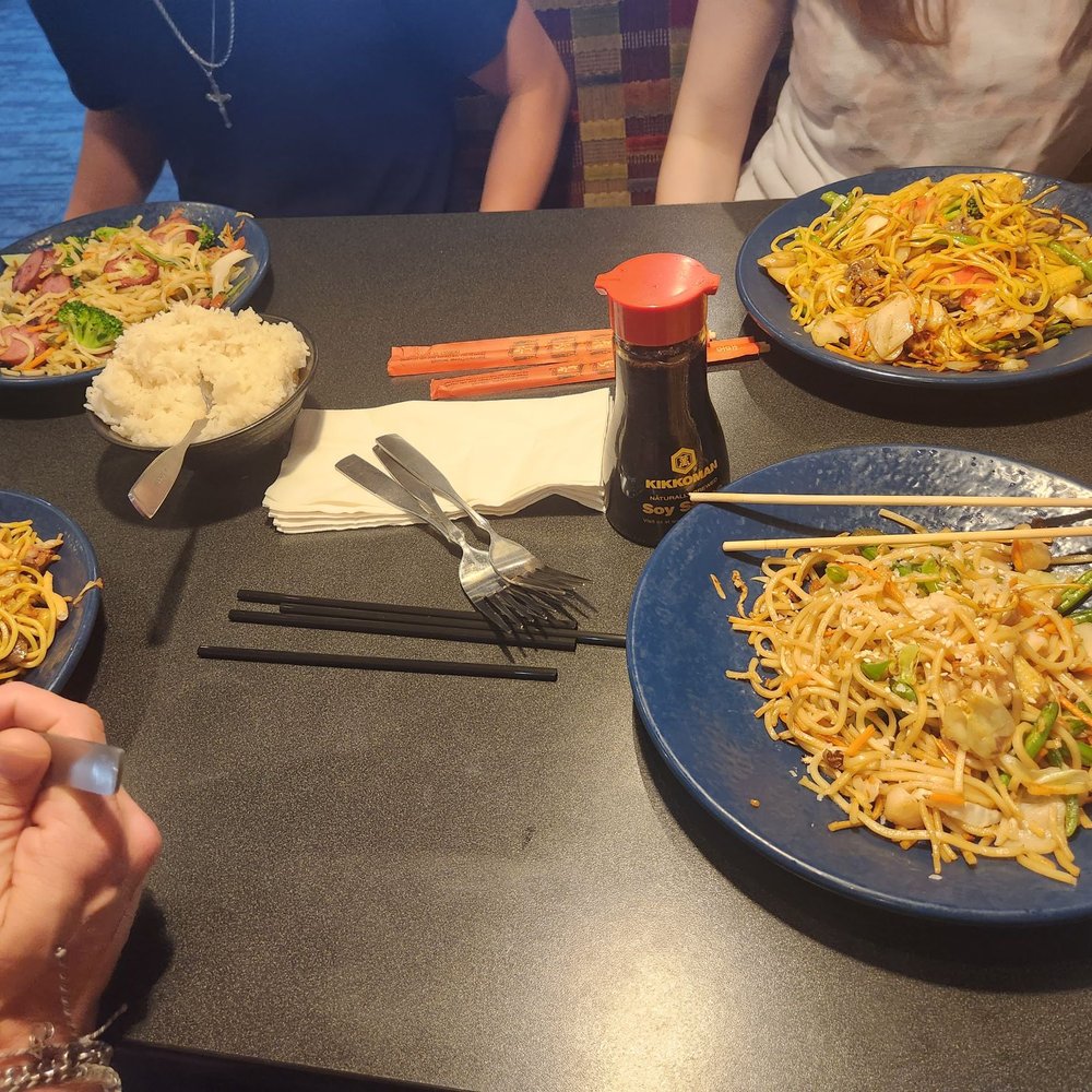 HuHot Mongolian Grill - a group of people sitting at a table with plates of food - Chinese Near Me - Lawrence, Kansas HuHot Mongolian Grill - a group of people sitting at a table with plates of food - Chinese Near Me - Lawrence, Kansas