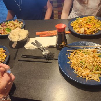 HuHot Mongolian Grill - a group of people sitting at a table with plates of food - Chinese Near Me - Lawrence, Kansas HuHot Mongolian Grill - a group of people sitting at a table with plates of food - Chinese Near Me - Lawrence, Kansas