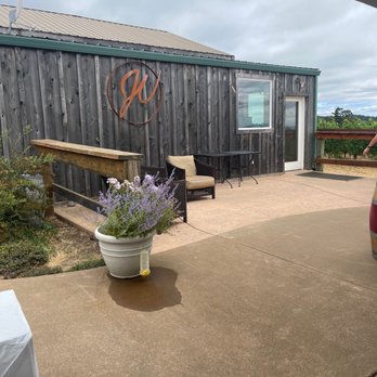 J Wrigley Vineyards - a patio with a table and chairs - Wineries Near Me - Sheridan, Oregon J Wrigley Vineyards - a patio with a table and chairs - Wineries Near Me - Sheridan, Oregon