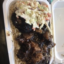 One Love Island Cuisine - Medium oxtail with a piece of jerk chicken and coleslaw