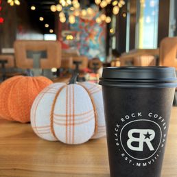 a coffee cup and pumpkins a coffee cup and pumpkins