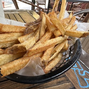Royale - a basket of french fries on a table - Burgers Near Me - New York, New York Royale - a basket of french fries on a table - Burgers Near Me - New York, New York