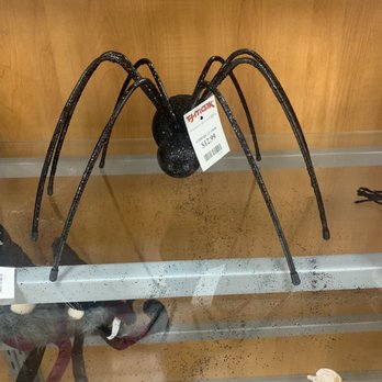 TJ Maxx - Halloween decor - A black spider Halloween decoration with long legs and a rounded body, displayed on a store shelf with a price tag of $12.99. - Department Stores Near Me - Plainfield, Indiana