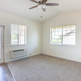 Silverplace Apartment Homes - A room with a ceiling fan and two windows. - Apartments Near Me - Silverton, Oregon Silverplace Apartment Homes - A room with a ceiling fan and two windows. - Apartments Near Me - Silverton, Oregon