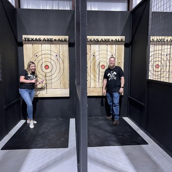 Texas Axe & Ale - a man and a woman standing in front of a target - Axe Throwing Near Me - Marion, Texas