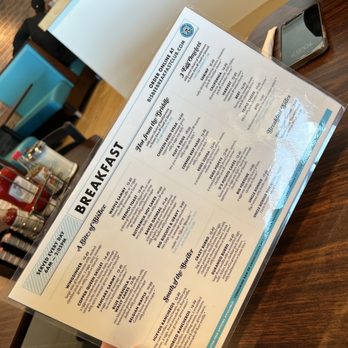 Bisbee Breakfast Club - a person holding a menu - Breakfast & Brunch Near Me - Tucson, Arizona Bisbee Breakfast Club - a person holding a menu - Breakfast & Brunch Near Me - Tucson, Arizona