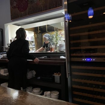 Daniel's Table - a woman preparing food in a kitchen - Mediterranean Near Me - Cathedral City, California