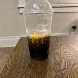 a plastic cup of coffee on a table