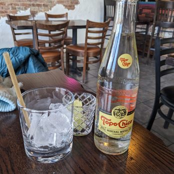 La Eskina Indy - Topo Chico, served chilled with optional ice, biodegradable straw, and lime slices. - Mexican Near Me - Indianapolis, Indiana