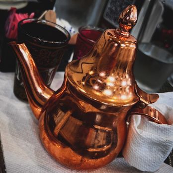 Daood Basha - a copper teapot on a table - Mediterranean Near Me - Orlando, Florida Daood Basha - a copper teapot on a table - Mediterranean Near Me - Orlando, Florida