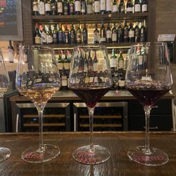 three glasses of wine on a bar three glasses of wine on a bar