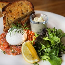 The Russian - Lemon house cured Salmon Tartare, Free Range Poached Egg, Cress, Dill Creme Fraiche, Multi-Grain Toast ($17.90)