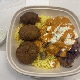 Falafel bowl with harissa sauce and side of tzatziki, sides include sweet potato, hummus, and feta Falafel bowl with harissa sauce and side of tzatziki, sides include sweet potato, hummus, and feta
