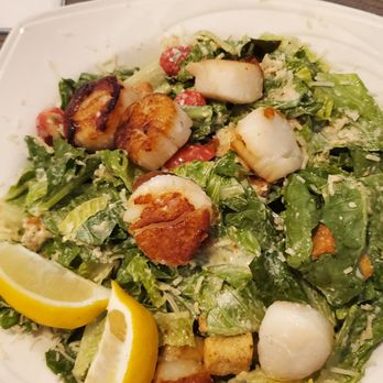 Atlantic Grille - Scallop Caesar Salad - A Caesar salad featuring grilled scallops, chopped romaine lettuce, cherry tomatoes, croutons, and grated cheese, garnished with lemon wedges. - Breakfast & Brunch Near Me - Middletown, Rhode Island