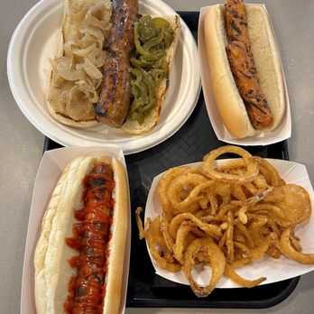 Juniors Hot Dogs - Italian sausage (top left), veggie hot dog (top right), regular hot dog (bottom left), small side of onion rings (bottom right) - Ice Cream & Frozen Yogurt Near Me - East Bradenton, Florida Juniors Hot Dogs - Italian sausage (top left), veggie hot dog (top right), regular hot dog (bottom left), small side of onion rings (bottom right) - Ice Cream & Frozen Yogurt Near Me - East Bradenton, Florida