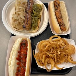 Juniors Hot Dogs - Italian sausage (top left), veggie hot dog (top right), regular hot dog (bottom left), small side of onion rings (bottom right)