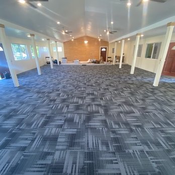 PLY Flooring - a large room with a ceiling fan - Flooring Near Me PLY Flooring - a large room with a ceiling fan - Flooring Near Me