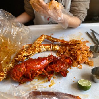 The Boiling Crab - a woman preparing to eat - Seafood Near Me - Cambridge, Massachusetts The Boiling Crab - a woman preparing to eat - Seafood Near Me - Cambridge, Massachusetts