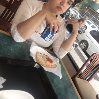 J's Pizza - My sister enjoying her cheese slice - Pizza Near Me - New York, New York J's Pizza - My sister enjoying her cheese slice - Pizza Near Me - New York, New York