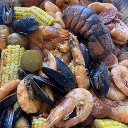 a bowl of seafood and corn a bowl of seafood and corn