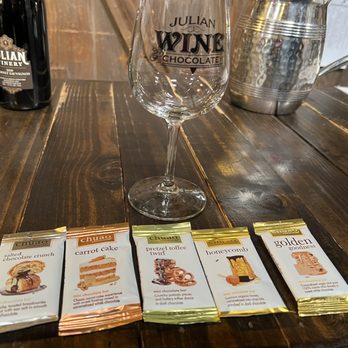 Julian Wine & Chocolate - a glass of wine and four packets of chocolate - Wine Tasting Room Near Me - Julian, California Julian Wine & Chocolate - a glass of wine and four packets of chocolate - Wine Tasting Room Near Me - Julian, California