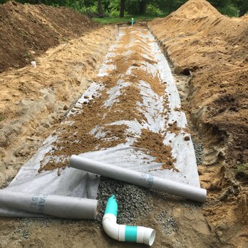 Valli Construction - a pipe laying on the ground - General Contractors Near Me - Portland, Connecticut