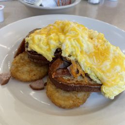 Scrambled eggs and cheese with cinnamon swirl French toast, sausage and potatoes. Scrambled eggs and cheese with cinnamon swirl French toast, sausage and potatoes.