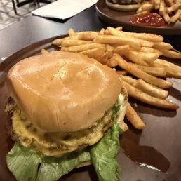 Classic burger with lettuce, tomato, green mayo and cheese.