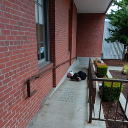 US Post Office - 1030 a.m. and a bum is sleeping