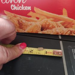 Crown Fried Chicken - Piece on plastic or glass under chicken skin.  Other smaller pieces in chicken coating.  Able to hear the crunch.