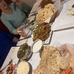 Goat Korma, Lamb Biryanis, Keema Matar, a variety of naan and roti and Mango Lassi.