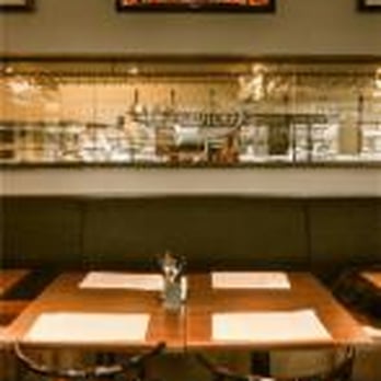 Lo Dico - a restaurant with a long table and chairs - Pizza Near Me - Repentigny, Quebec