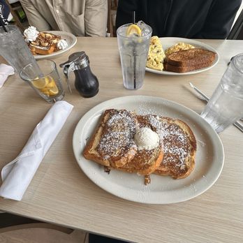 The Toasted Yolk Cafe - French Toast at the bottom. Banana Frost French Toast top left. Big Ben Omelette top right. - Breakfast & Brunch Near Me - Rosenberg, Texas