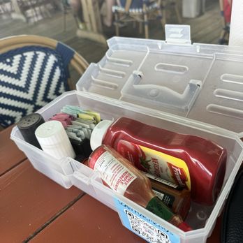 Crabby Joe's Deck & Grill - Tackle box with condiments. - Seafood Near Me - Daytona Beach, Florida