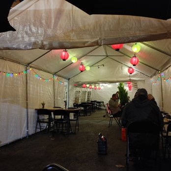 Paella Bar - people sitting at tables under a tent - Tapas Bars Near Me - Poulsbo, Washington Paella Bar - people sitting at tables under a tent - Tapas Bars Near Me - Poulsbo, Washington