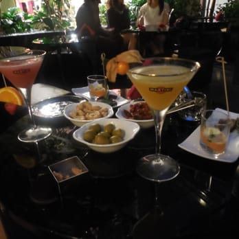 Dolce & Gabbana Martini - Apperitivo spread with Dolce&Gabanna signature cocktail on the left - Bars Near Me - Milan, Michigan