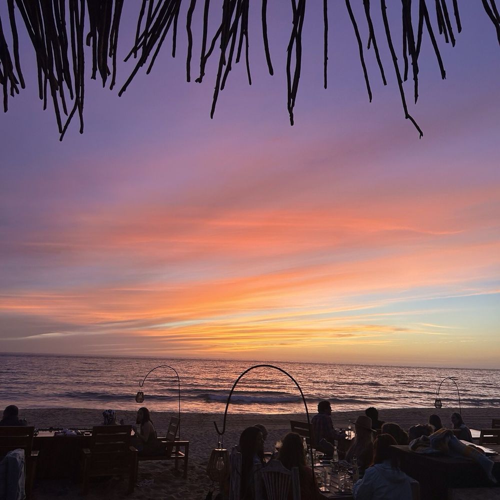 Sitting at your table in the sand while watching the sunset Sitting at your table in the sand while watching the sunset