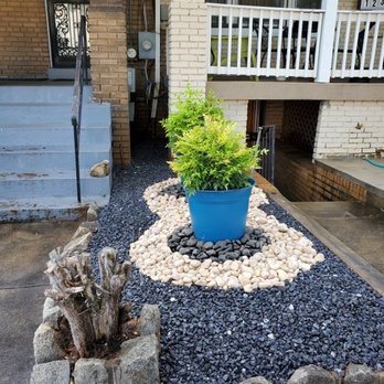 JC's Landscaping - a potted plant in a rock garden - Gardeners Near Me