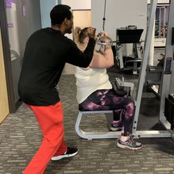 Anytime Fitness - Trainer & client on the cable machine