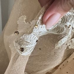 Glued-on appliqué, falling apart.