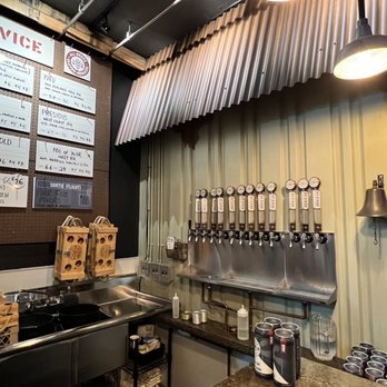 At Ease Brewing Company - a counter with a variety of beers - Breweries Near Me - Sacramento, California At Ease Brewing Company - a counter with a variety of beers - Breweries Near Me - Sacramento, California