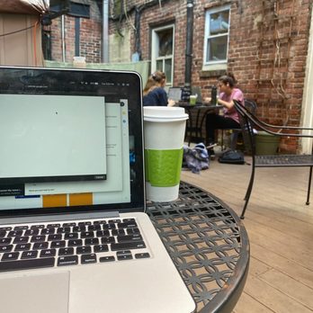 Good Karma Cafe - a laptop on a table - Coffee & Tea Near Me - Philadelphia, Pennsylvania