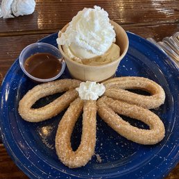 Churro with ice cream and caramel sauce Churro with ice cream and caramel sauce